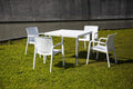 Set of Two White Faux Rattan Heavy Duty Plastic Outdoor Stacking Arm Chairs